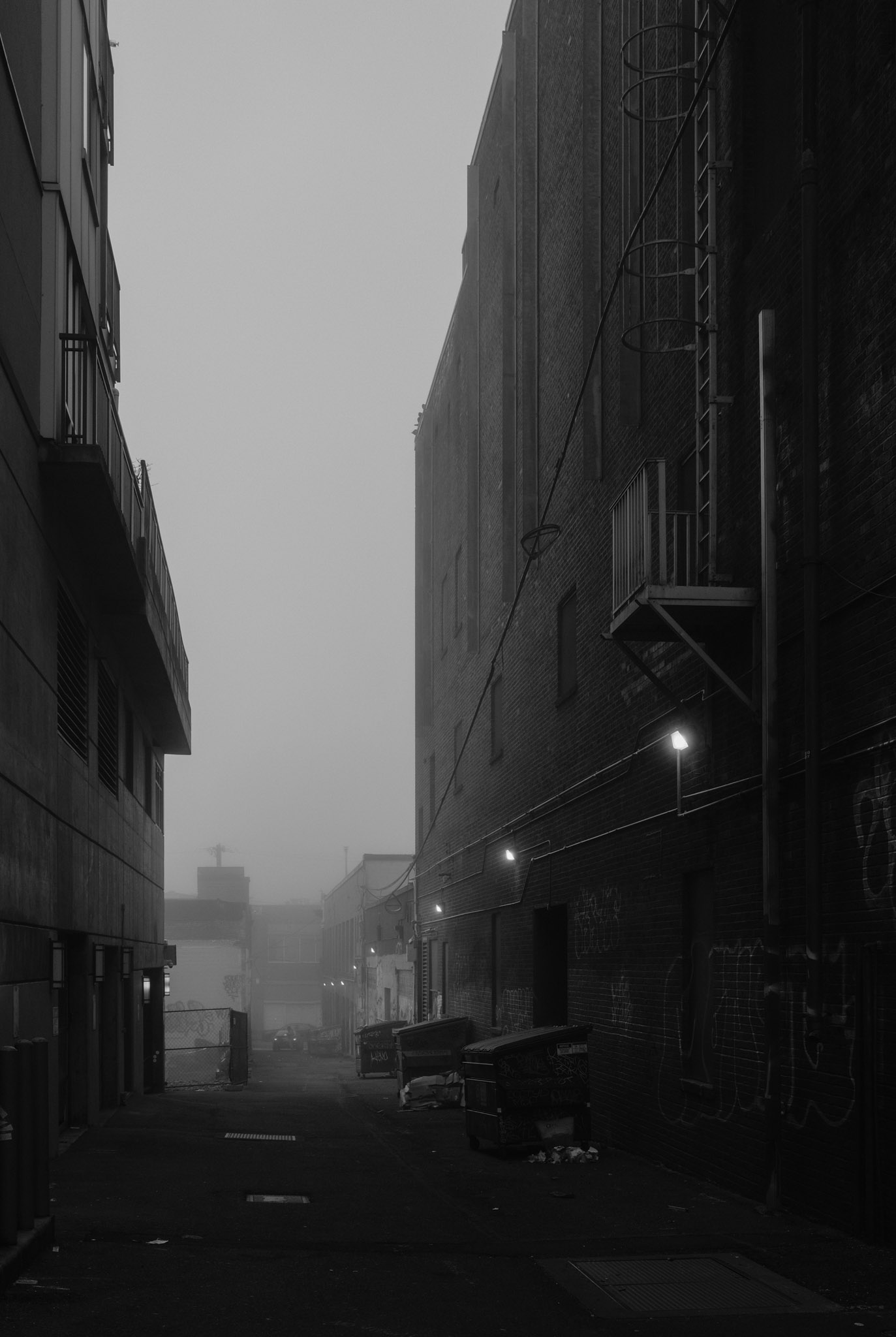 Creepy alley with fog on the street
