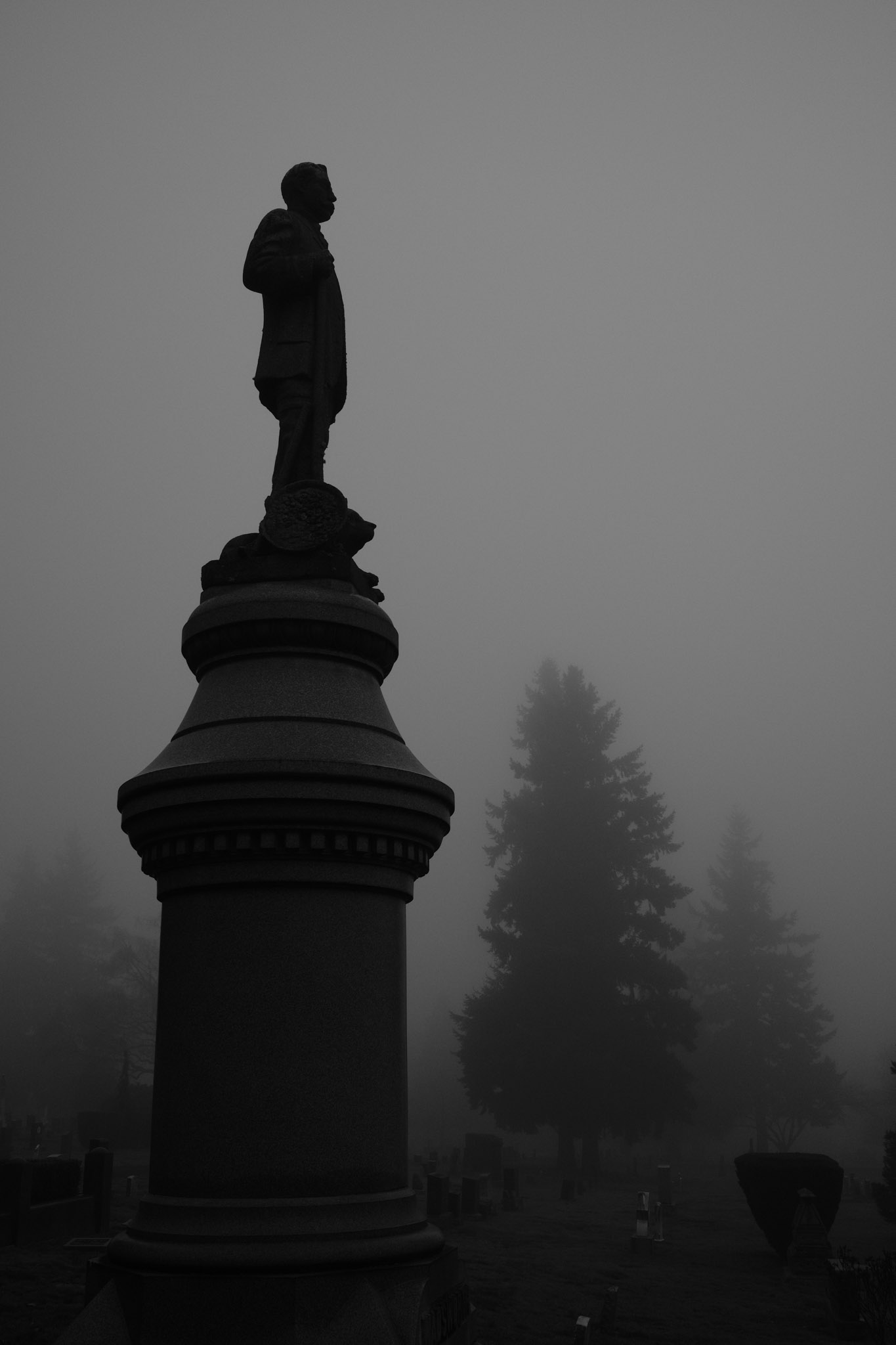 A dark figure standing upon a pillar